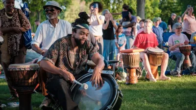 Drummers in a drumming circle in a park.