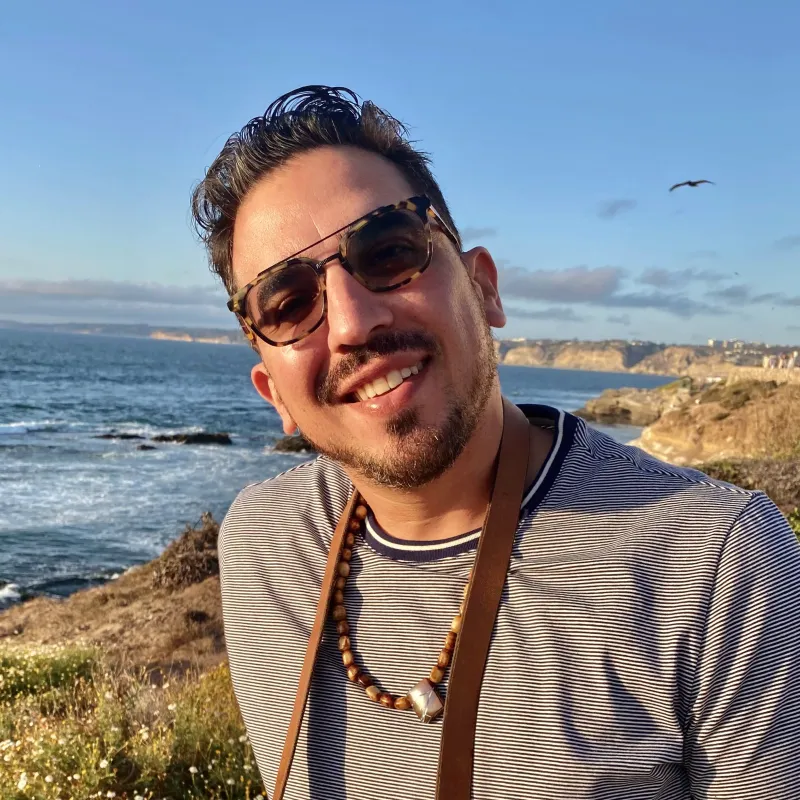 portrait of a person in front of the ocean