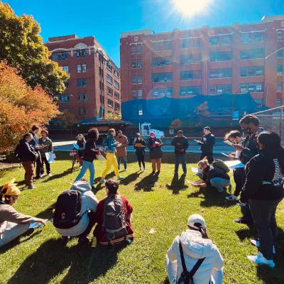 About 20 organizers gathering on a sunny, grassy area.